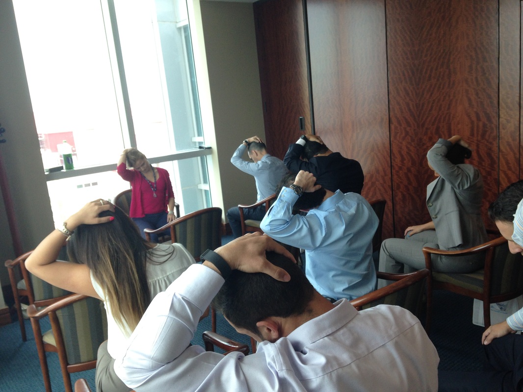 Corporate chair yoga session at Sabadell Bank — workplace wellness Miami