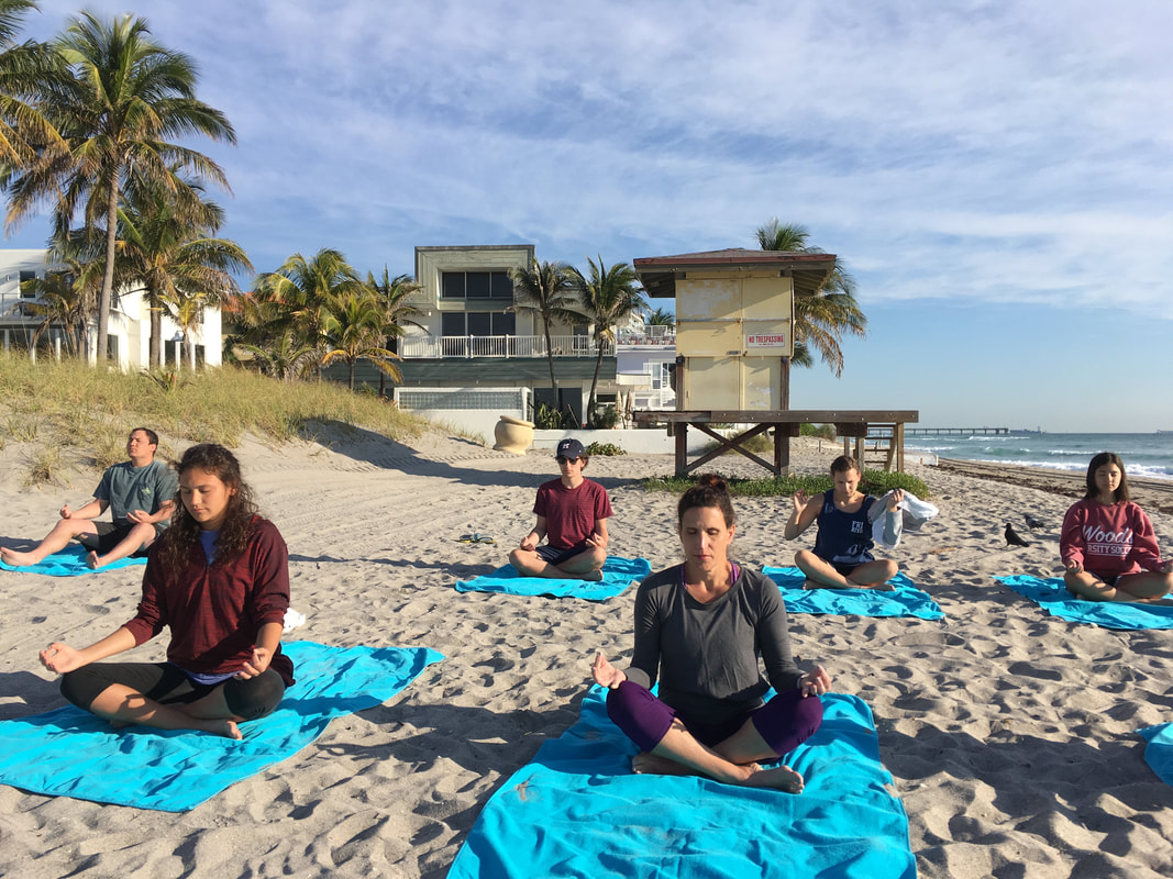 Corporate outdoor wellness session — beach meditation Miami